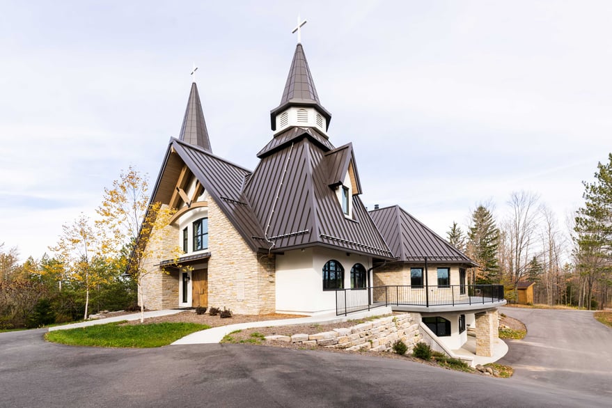 exterior entrance C.D. Smith Construction Manager for Camp Vista chapel project with wood beams, stone wall masonry and patio