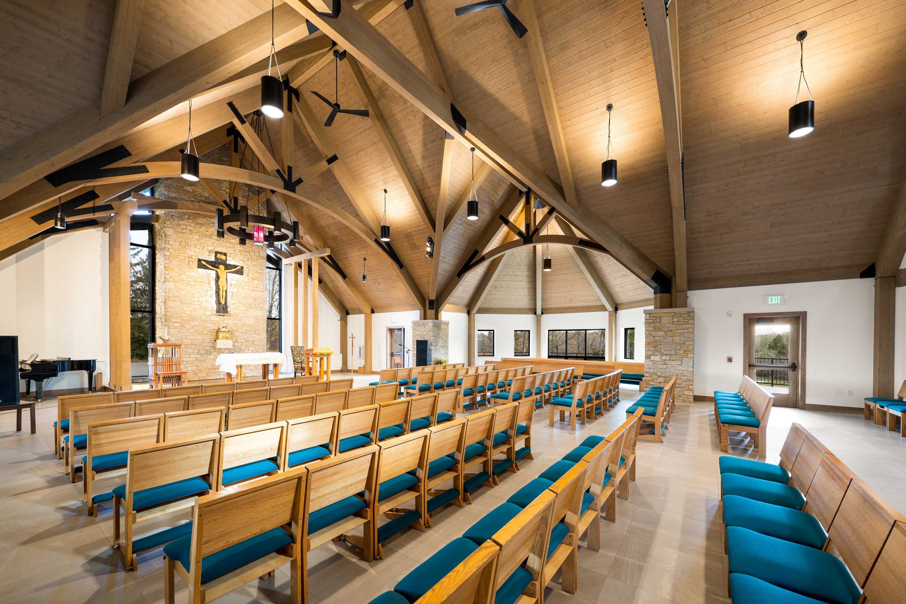 chapel interior C.D. Smith Construction Manager for Camp Vista chapel project with wood beams, stone wall masonry and patio