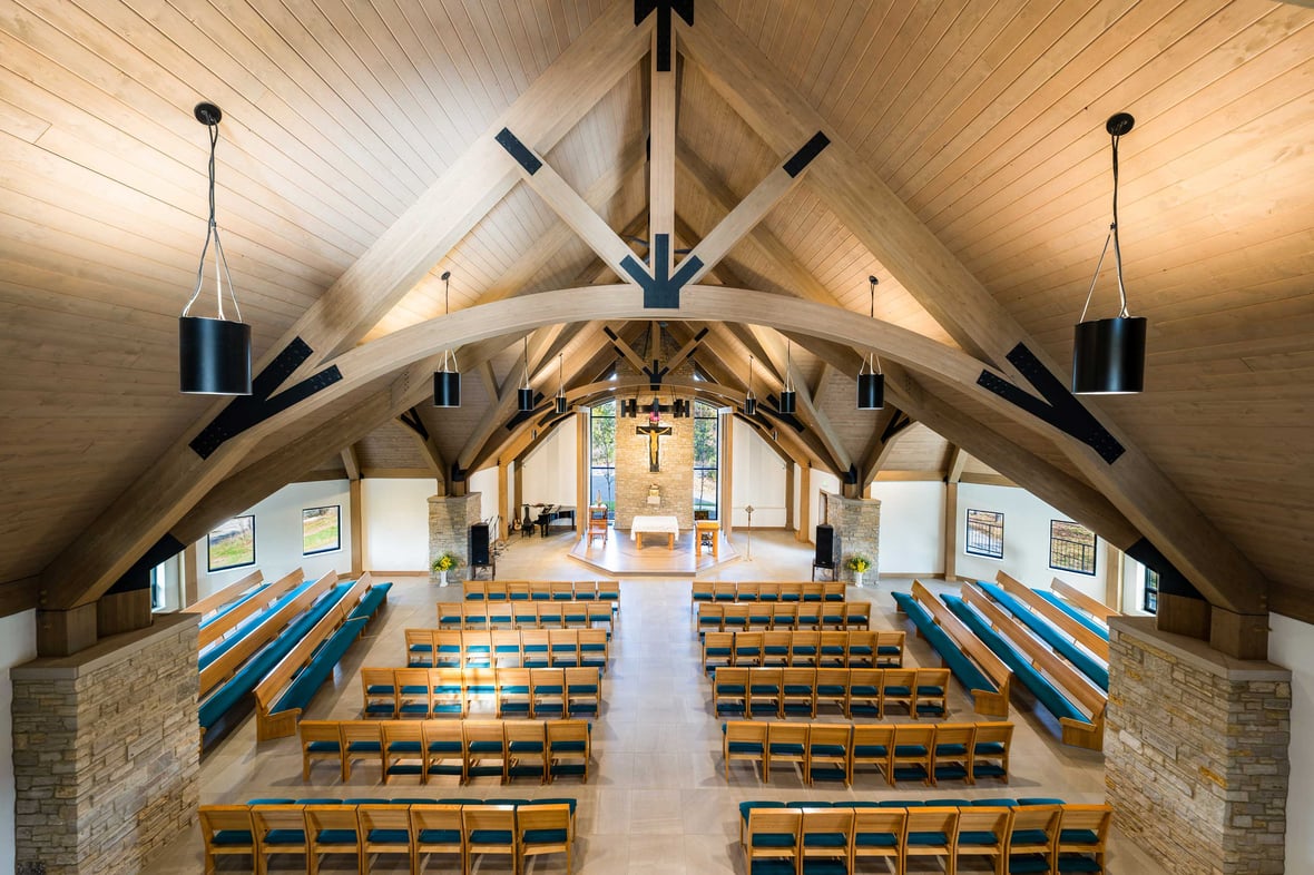 chapel interior C.D. Smith Construction Manager for Camp Vista chapel project with wood beams, stone wall masonry and patio