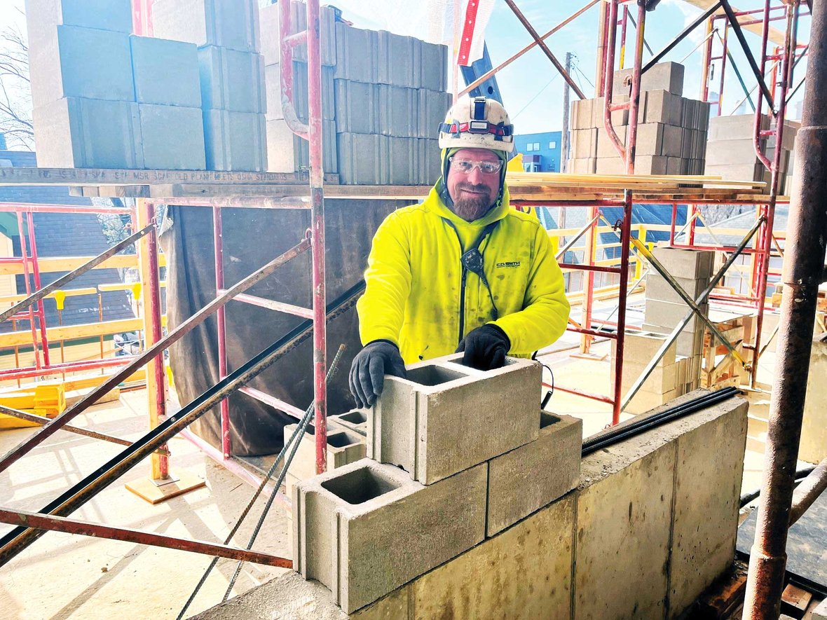 C.D. Smith masons placing block at Levy Hall in Madison, Wisconsin, demonstrating precision and craftsmanship.