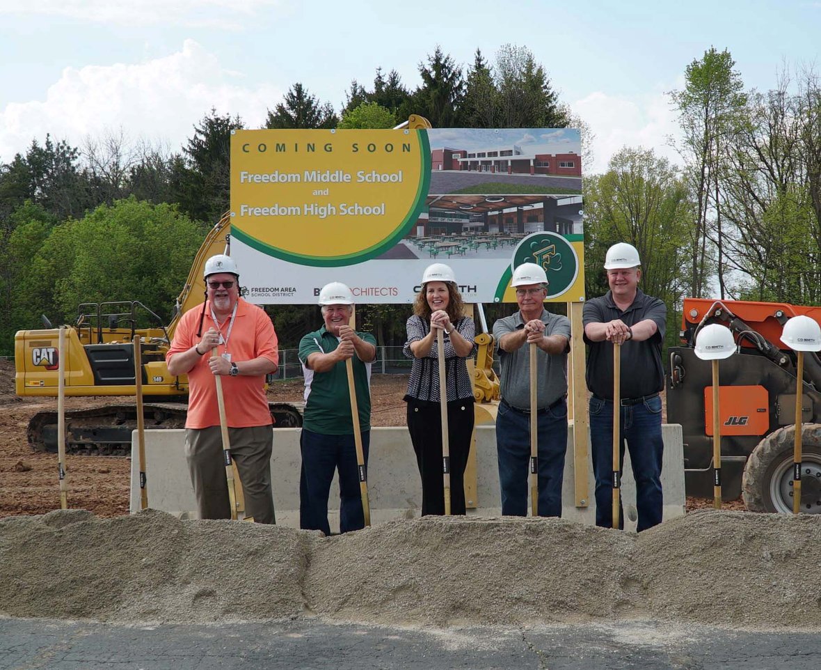Freedom Area School District leaders, students and community members participate in the ceremonial groundbreaking with shovels at the construction site.