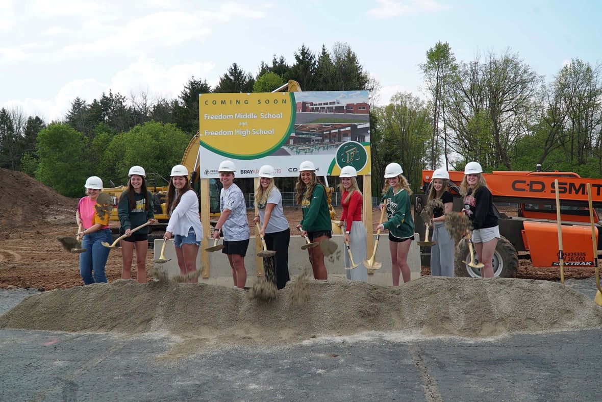 Freedom Area School District leaders, students and community members participate in the ceremonial groundbreaking with shovels at the construction site.