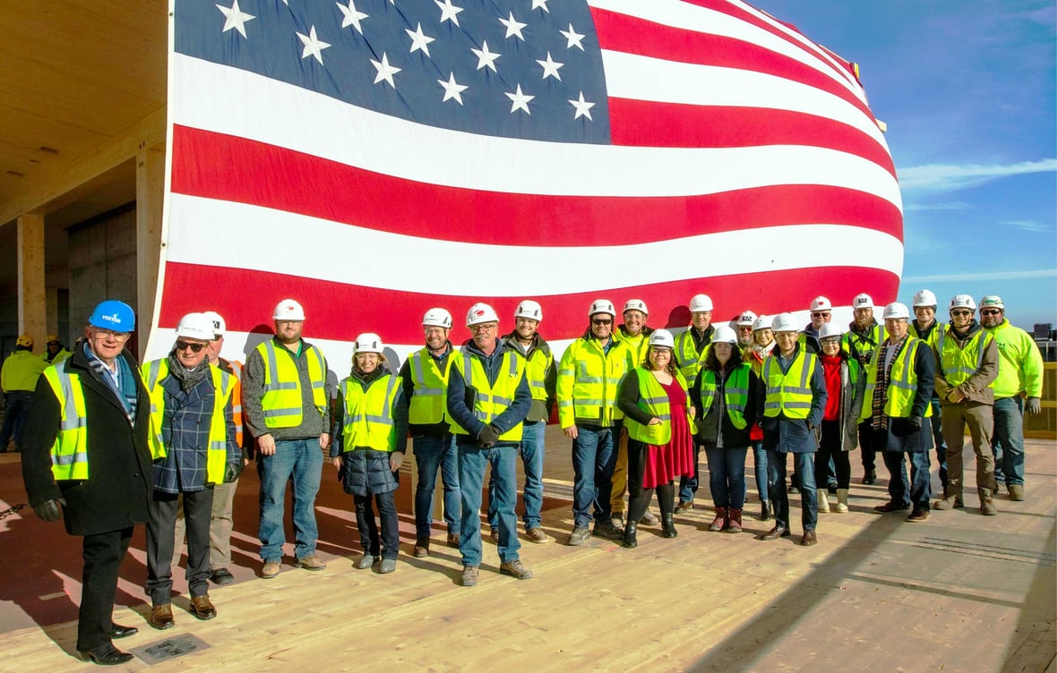 Stakeholders group photo on 25th floor to celebrate topping off Ascent mass timber tower as world's tallest with C.D. Smith Construction