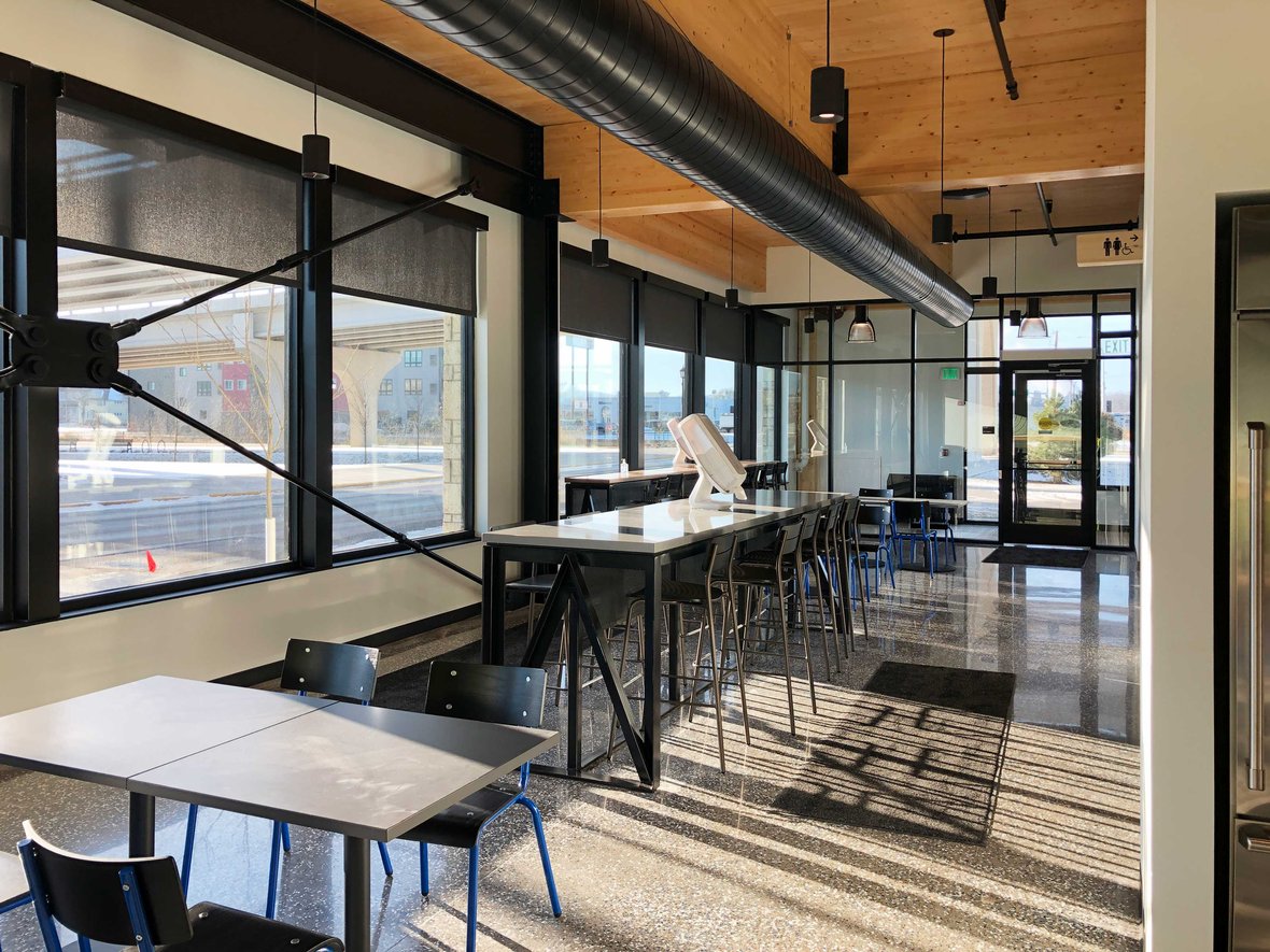 New corporate office interior exposed wood beams at Fastenal Company's mass timber building