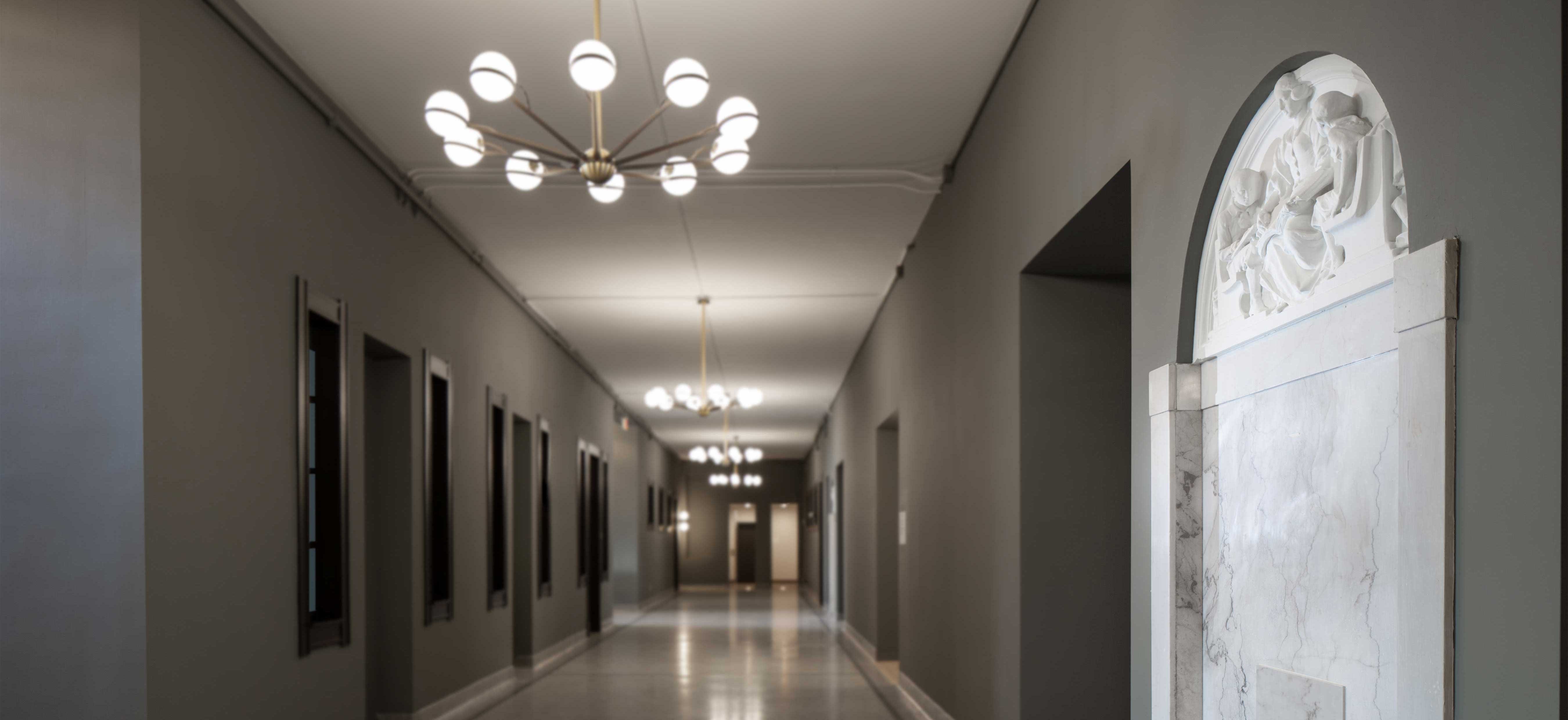 Whitney School Lofts historic construction rehabilitation project corridor with wall decor