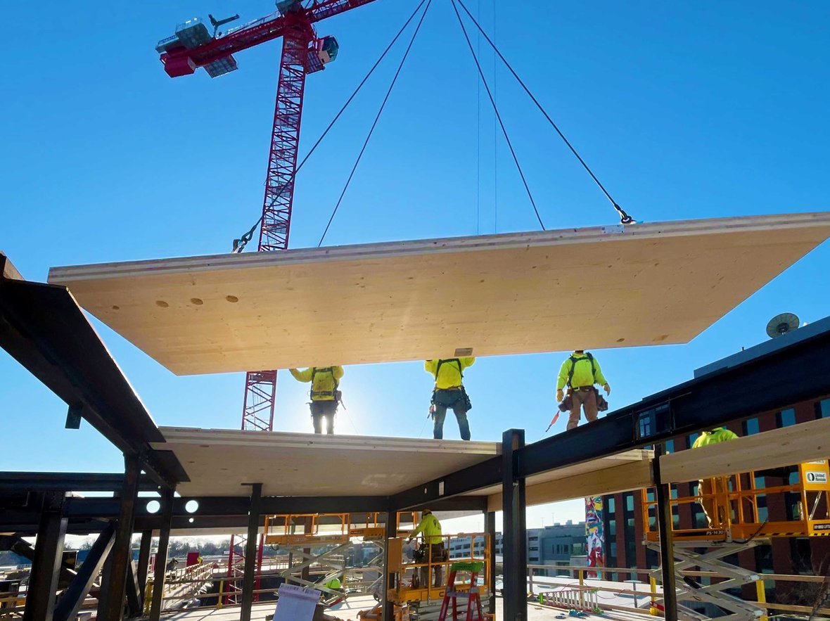 CD Smith Construction ironworkers and carpenters installing flying timber at Bakers Place mass timber building in Madison Wisconsin