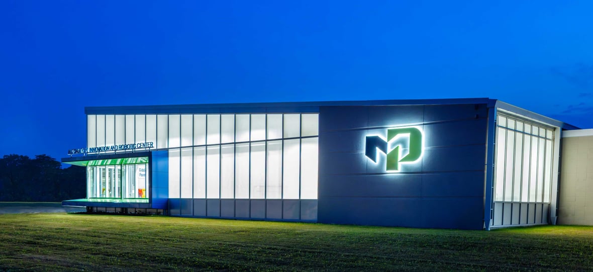 Exterior facade of the newly built Moraine Park Technical College AIR Center illuminated at dusk in Fond du Lac, Wisconsin.