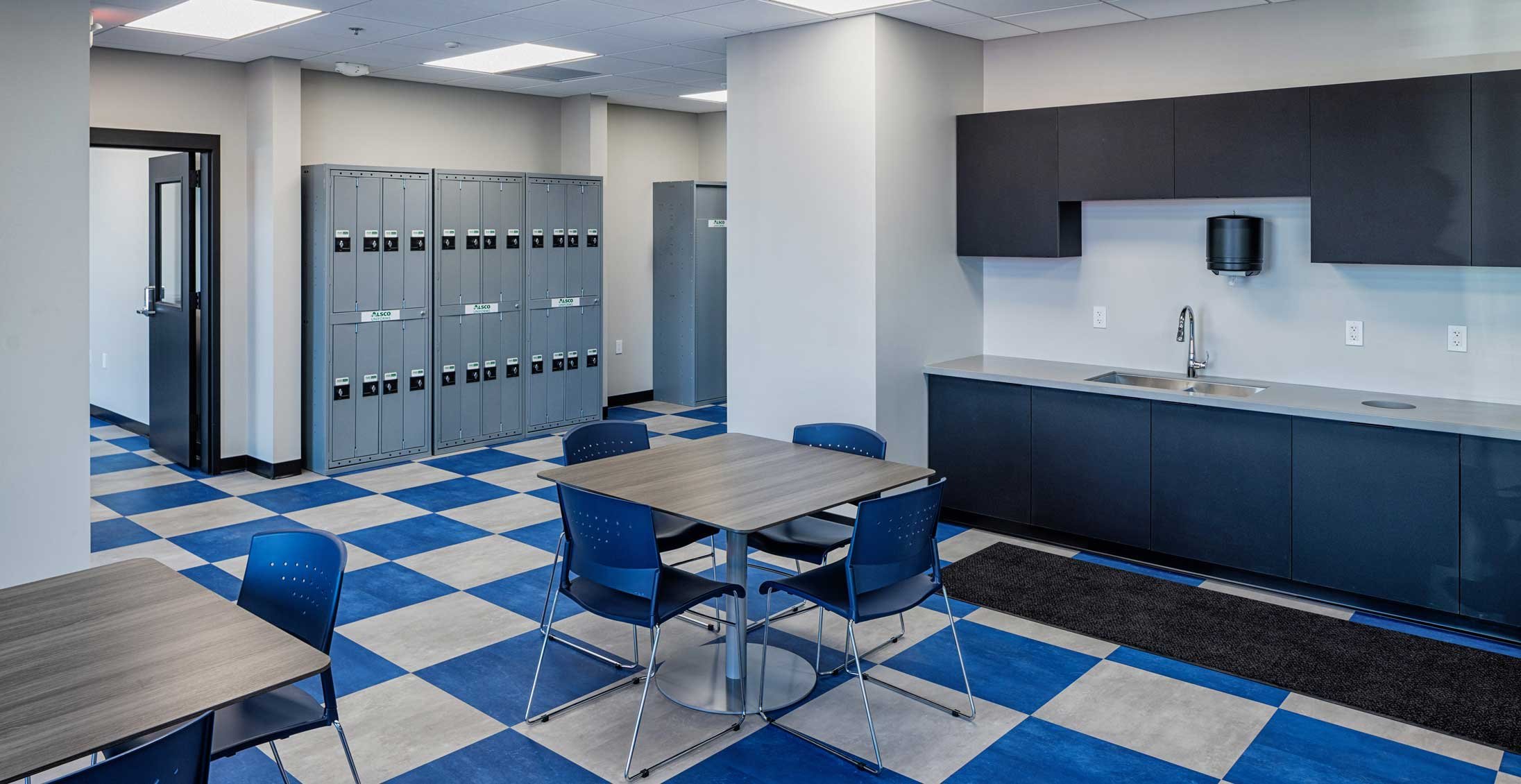 Employee break room and support space at Holiday Automotive Reconditioning Tech Center with lockers, kitchenette and staff amenities.