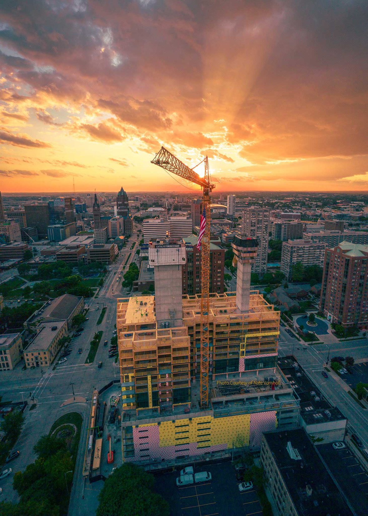 Aerial drone footage of mass timber construction and crane working on Ascent high-rise in Milwaukee, Wisconsin