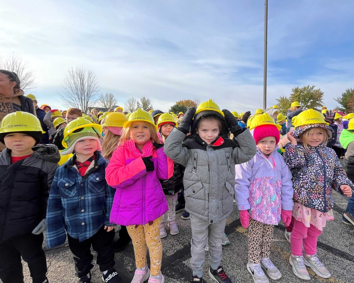 Kindergarten students in CD Smith Construction hard hats at Pulaski School District Sunnyside Project Groundbreaking