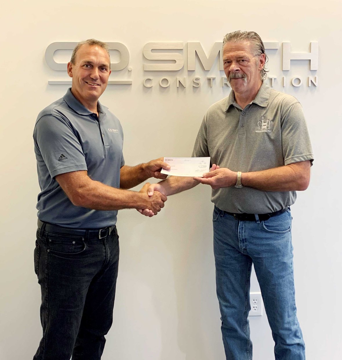 Jasen Anhalt (at left) pictured with SHP WI-La Crosse Chapter President Mike Suchla at C.D. Smith Construction's La Crosse Office