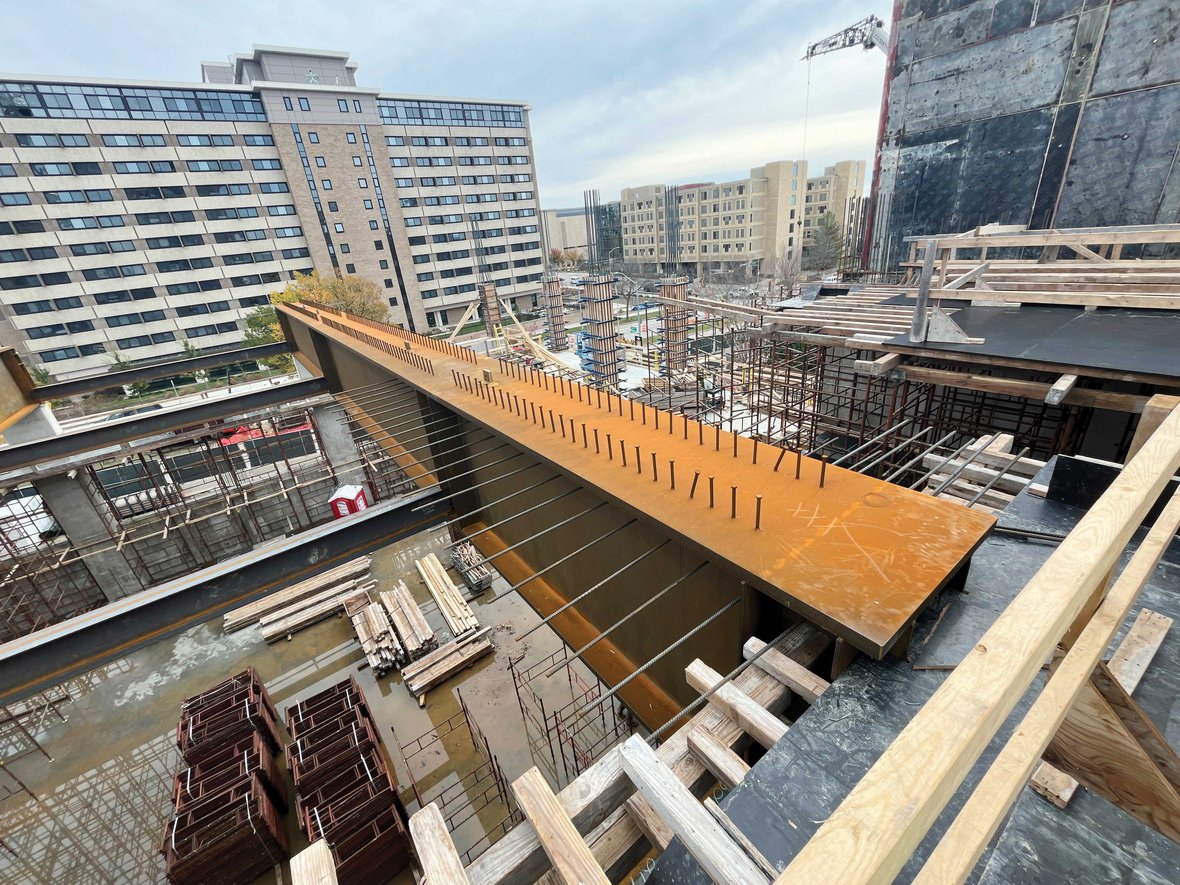 Aerial view of Levy Hall construction site at UW–Madison featuring green roofs and steel framework for lecture halls.