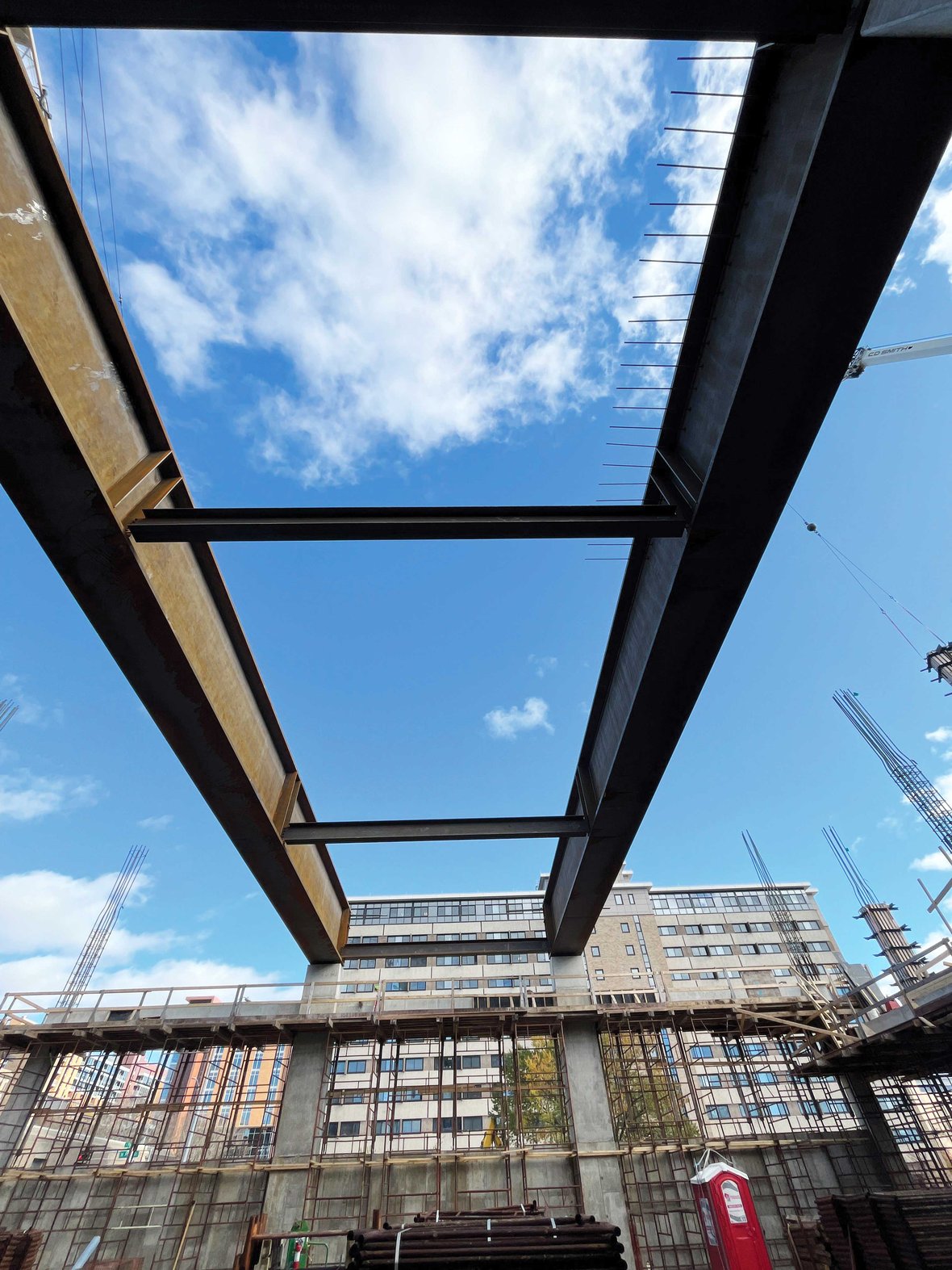 Completed girder installation showcasing structural integrity and teamwork behind Levy Hall’s multi-level construction and integration with existing university buildings.