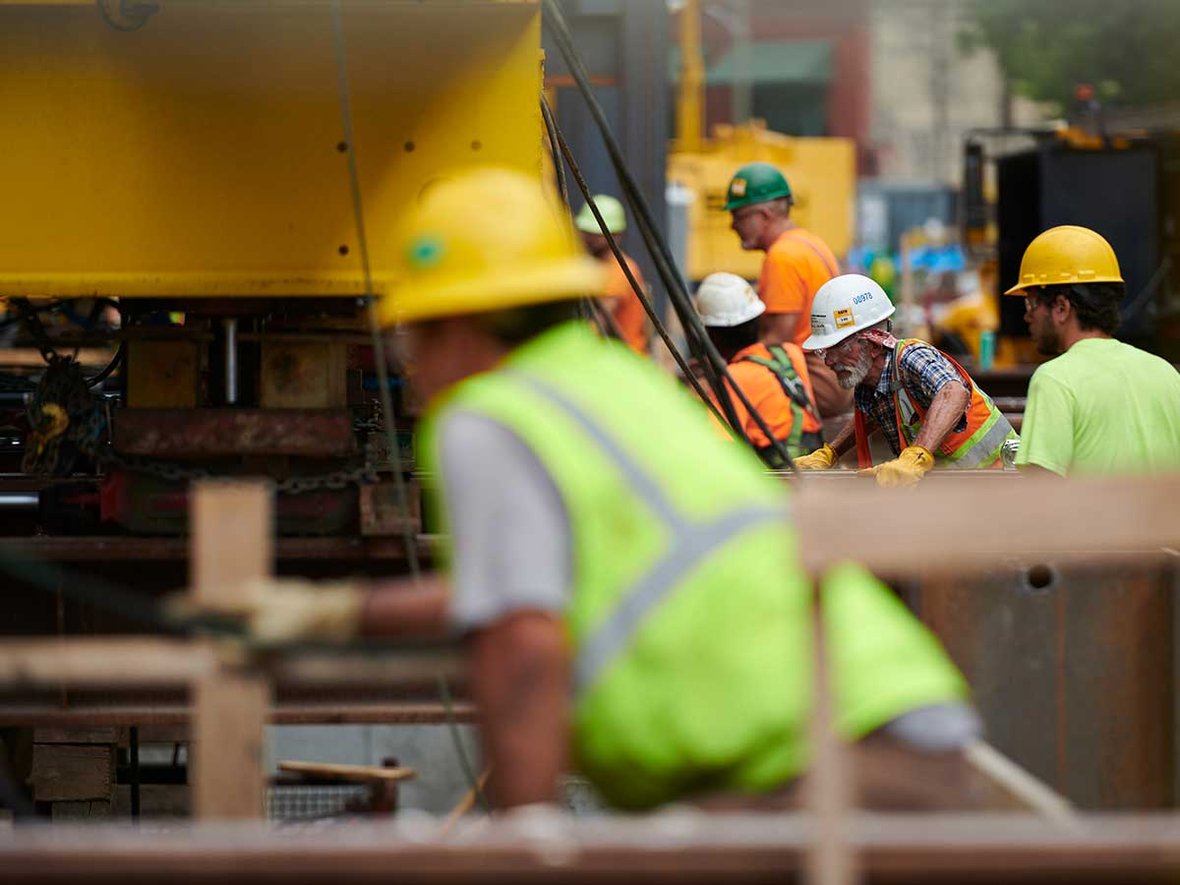 Ground level construction workers monitoring progress on the historic wall move for Milwaukee Symphony Orchestra's Bradley Symphony Center Project