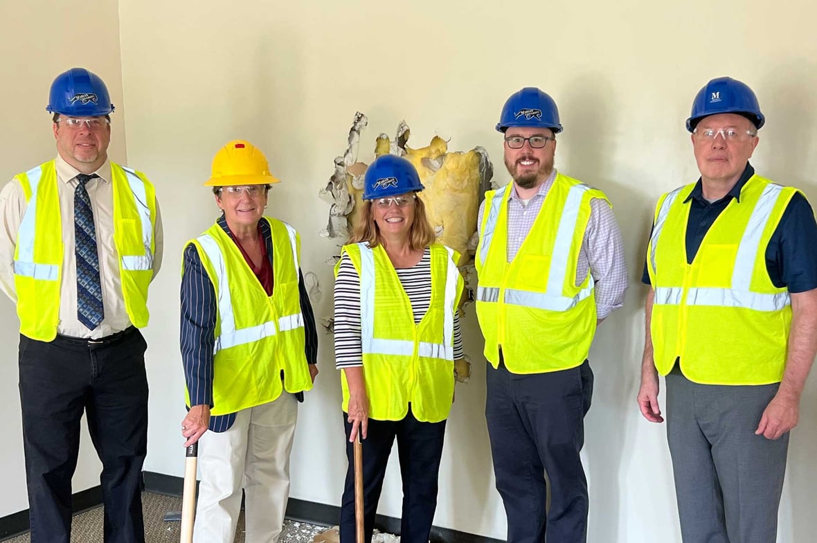 Marian University Executives pose with sledgehammers for construction demolition bash celebration at new home of the Nursing Program