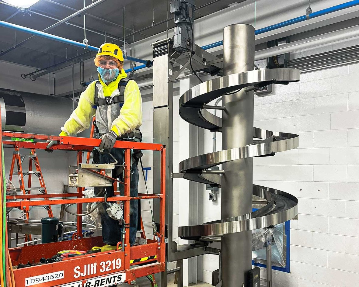 Millwrights installing industrial food processing equipment during a manufacturing facility upgrade