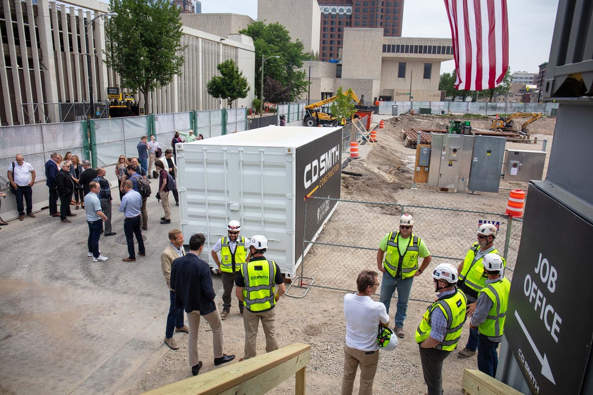 Neutral Edison groundbreaking attendees and CD Smith Construction crew outside jobsite trailers before ceremony for mass timber building in Milwaukee