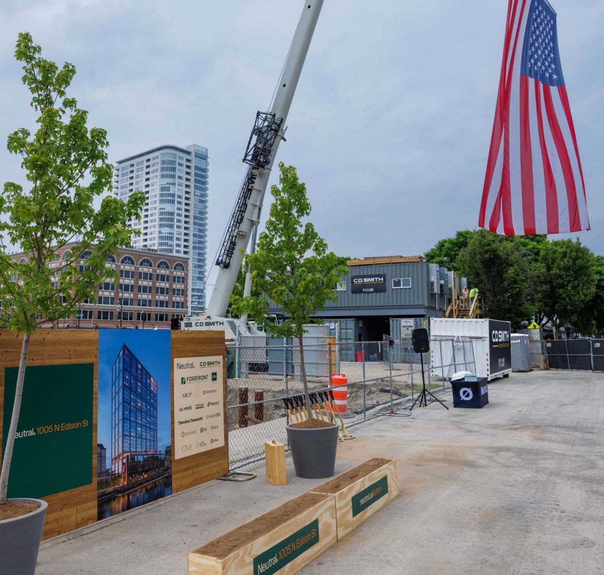 Neutral Edison mass timber project groundbreaking setup with crane and flag and dirt for shovels and ceremony in Milwaukee Wisconsin