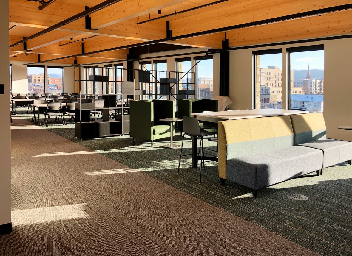 New Fastenal Office interior mass timber building columns and beams with views of downtown Winona, Minnesota