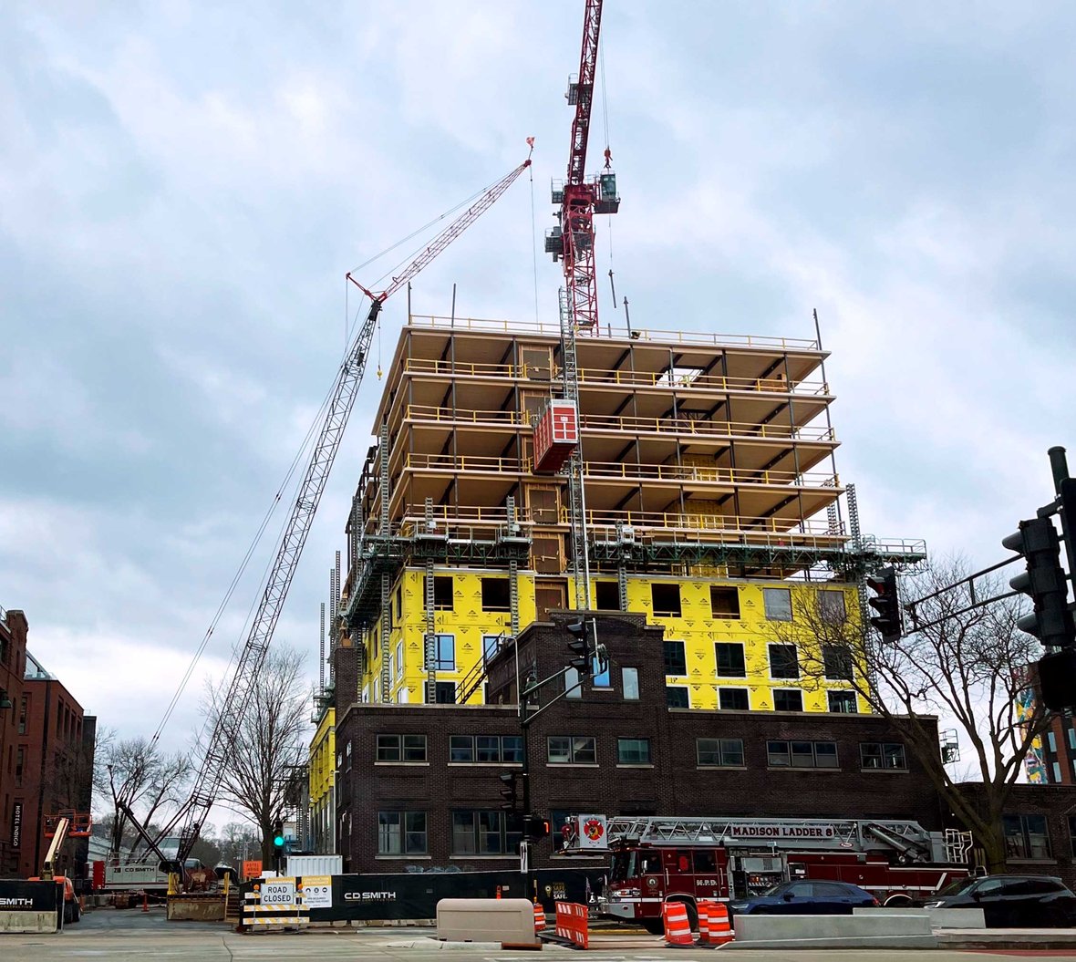 Photo-from-street-of-Bakers-Place-Mass-Timber-Building-Construction-in-Madison-Wisconsin-with-CD-Smith-cranes-and-equipment-on-the-project