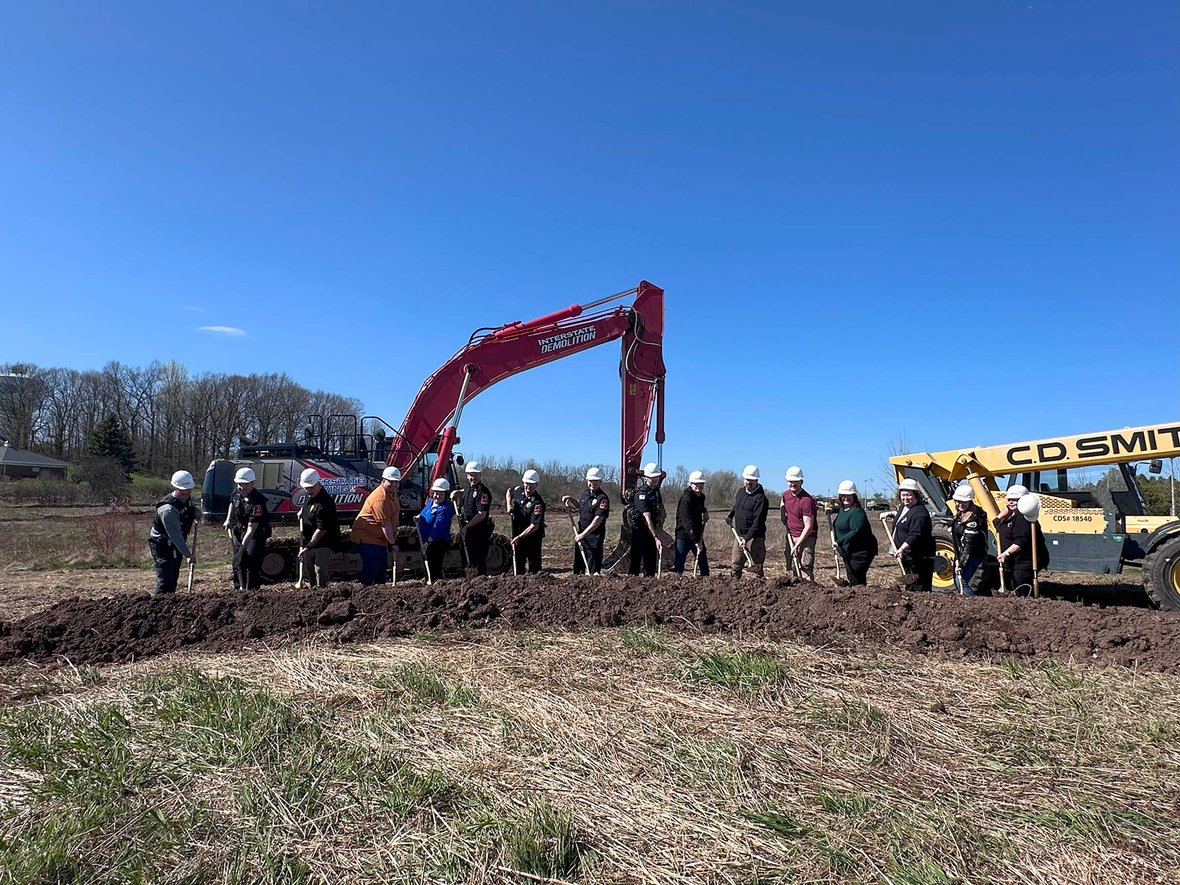 Groundbreaking ceremony group photo featuring Port Washington’s police, fire, and city leadership teams on the construction site of Wisconsin’s Public Safety Building.