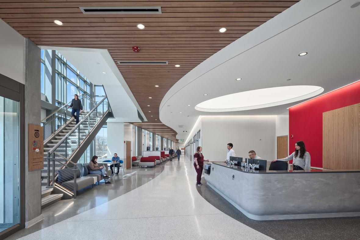 Reception desk and hallway leading to exam rooms with modern staircase at UW-Madison Veterinary Medicine entrance in Wisconsin