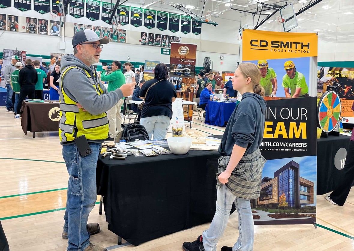 Superintendent Jason Zwiefel from C.D. Smith Construction talking to a student about careers in the trades at the Rhinelander High School Career Fair.