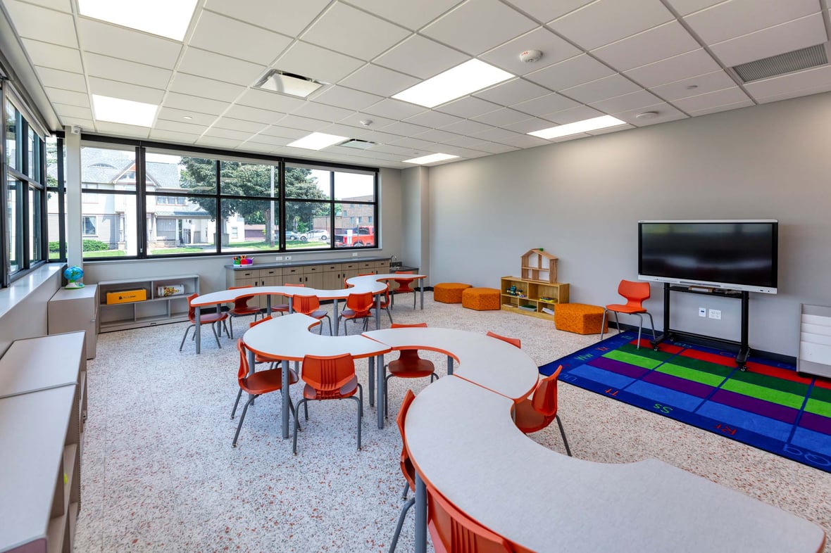 Classroom space at the Ripon Boys &amp; Girls Club designed for young children, featuring low tables, colorful chairs, and learning materials—part of a youth-focused facility built through commercial construction services in Wisconsin to support early education and development.
