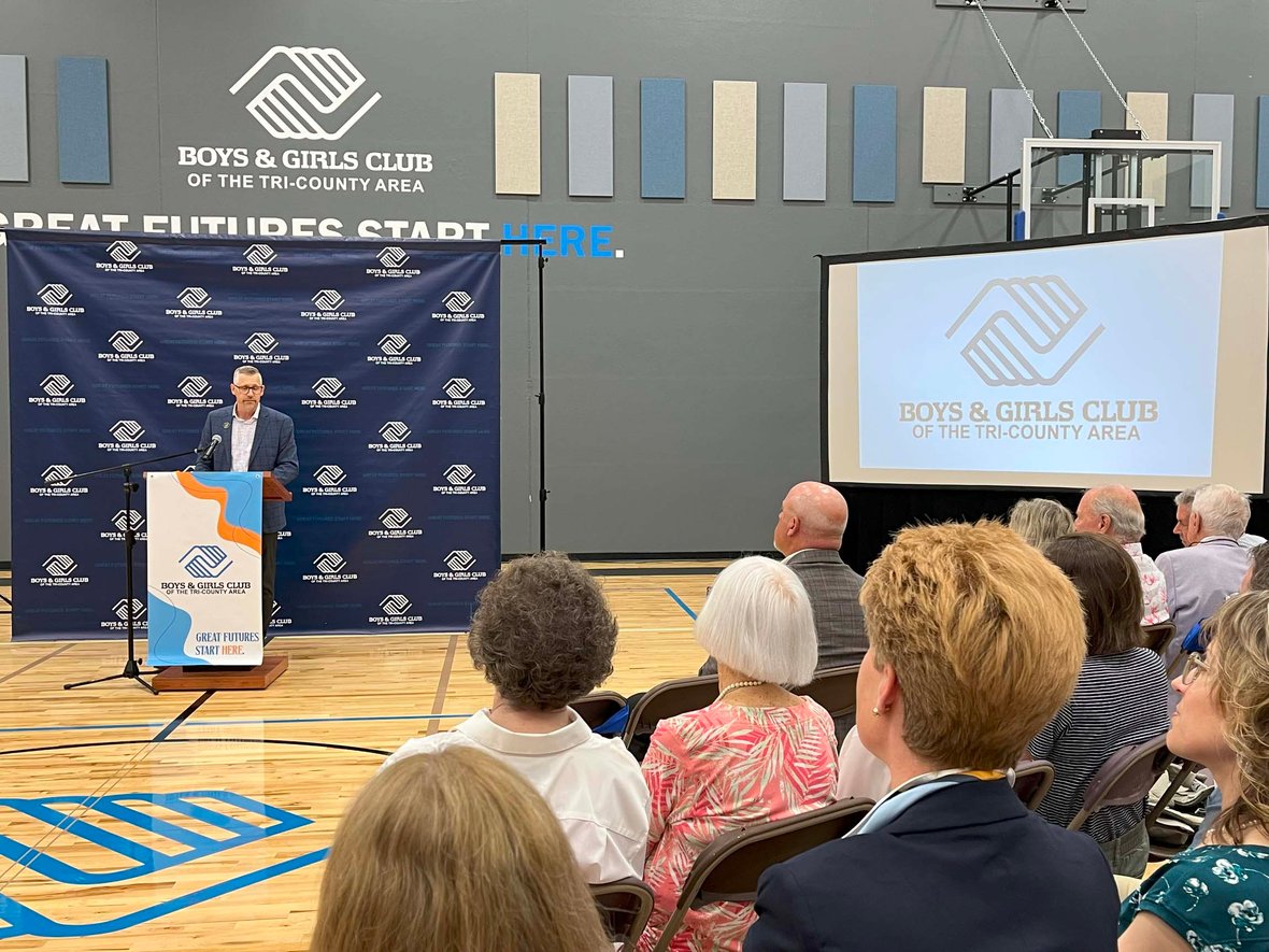 Jason Presto, CEO of the Boys &amp; Girls Club of the Tri-County Area, speaks to a full gymnasium of Ripon community members during the ribbon cutting ceremony for the new youth-focused facility built through commercial construction services in Wisconsin.