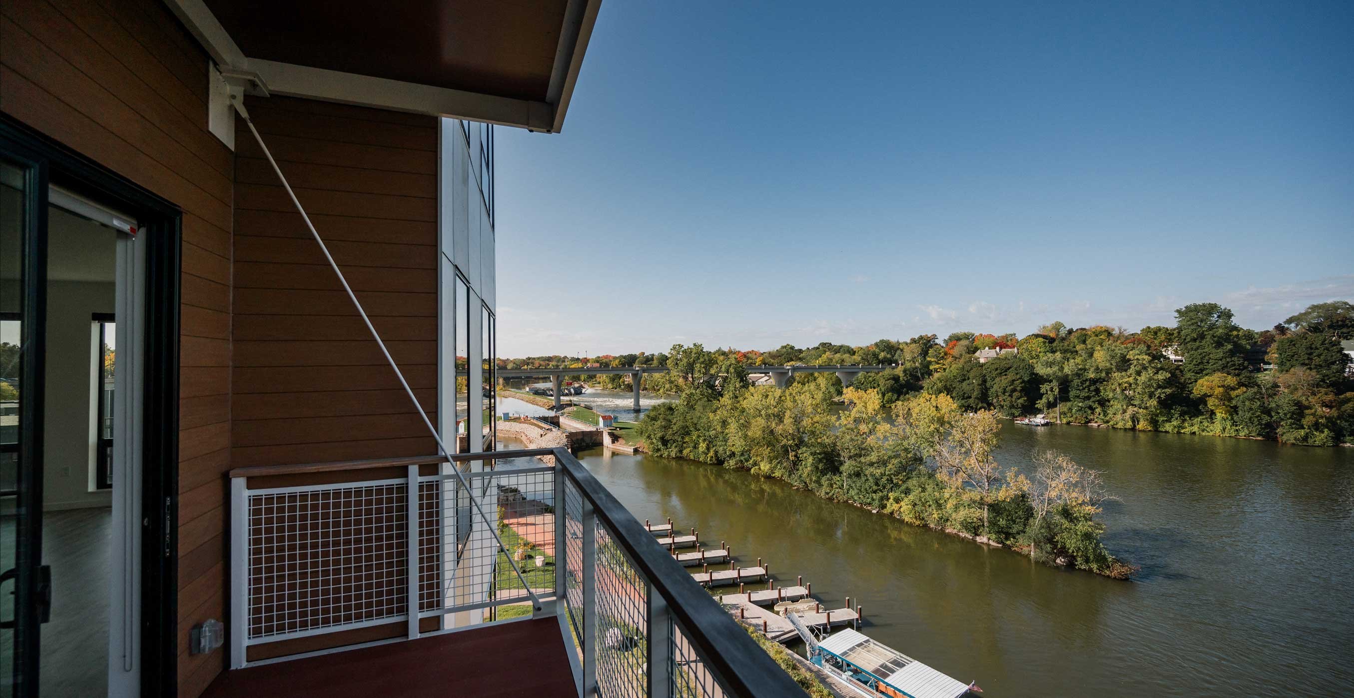 Private apartment balcony at RiverHeath Willow overlooking the river and surrounding green space.