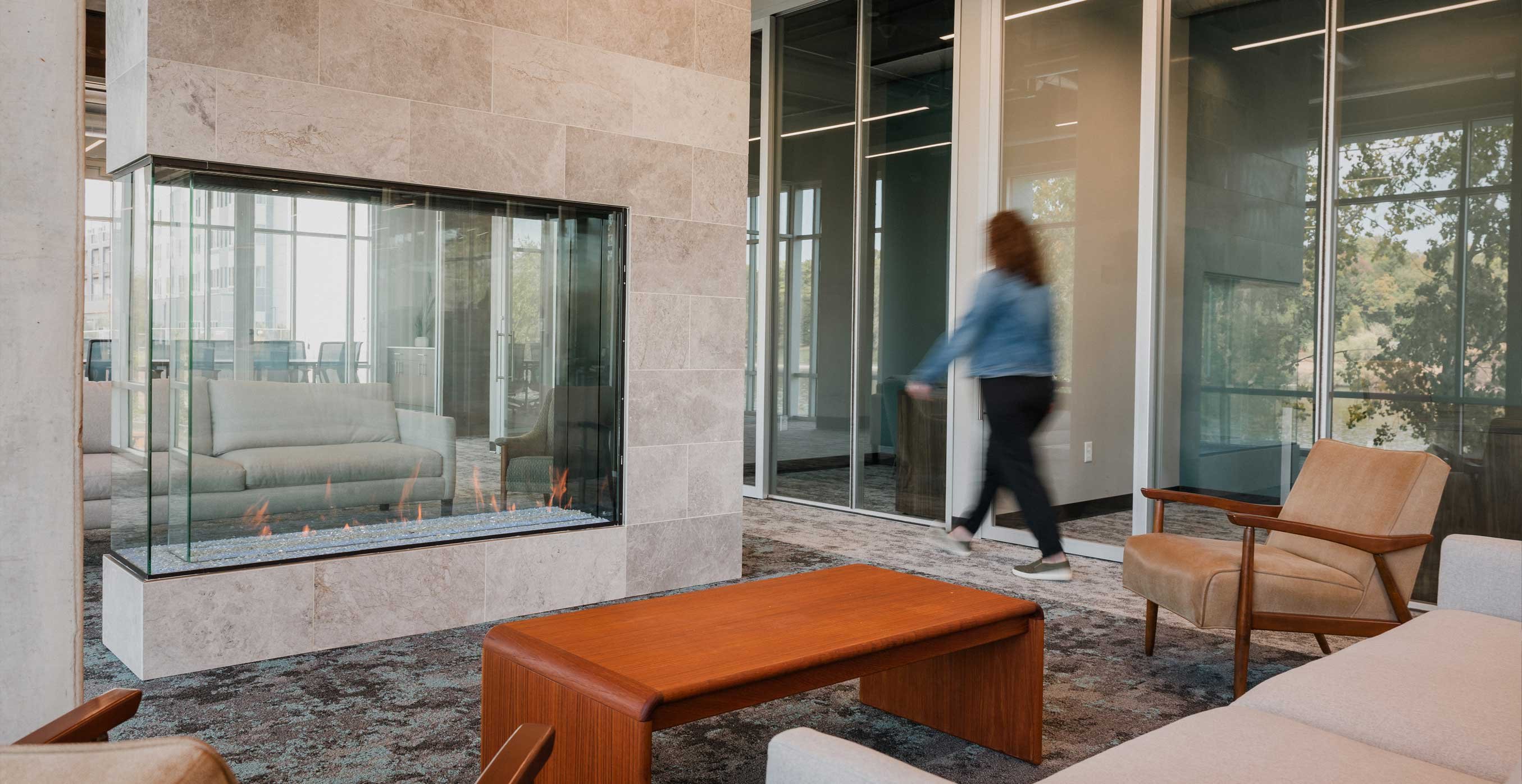 RiverHeath Willow office and lounge space with glass walls, fireplace feature, and modern seating.