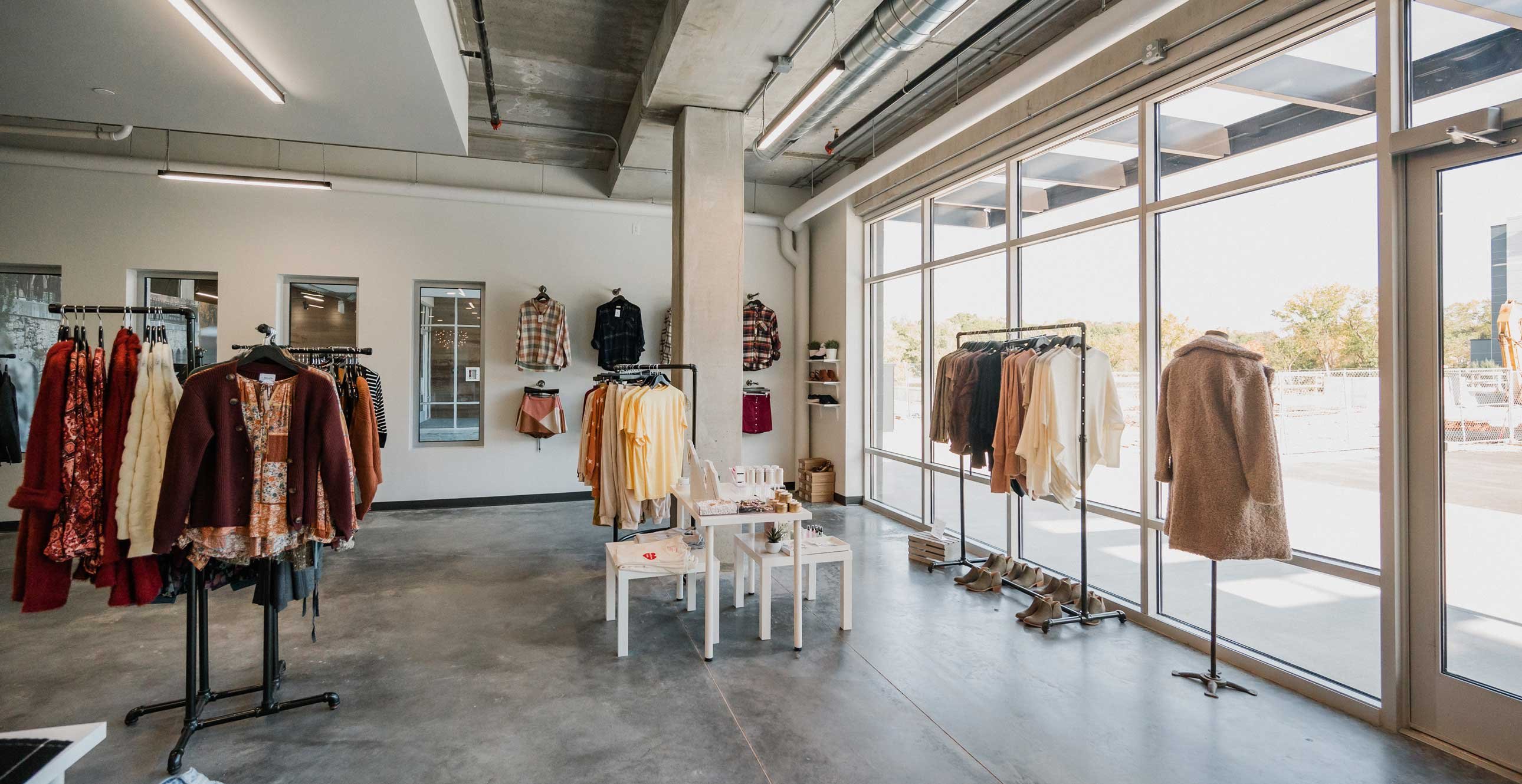 RiverHeath Willow mixed-use development boutique retail interior with modern industrial finishes and large storefront glazing.