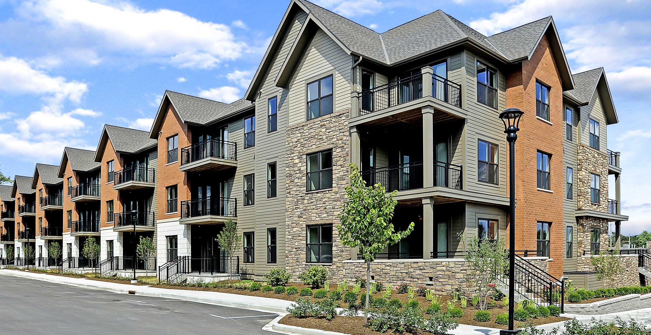 Spur 16 apartment building exterior with balconies and mixed-material facade in Mequon, Wisconsin.