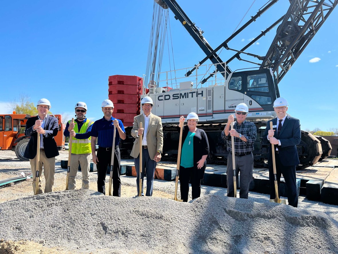 Stakeholders with shovels at groundbreaking for Ripon Boys & Girls Club with Wisconsin CD Smith Construction crane in background