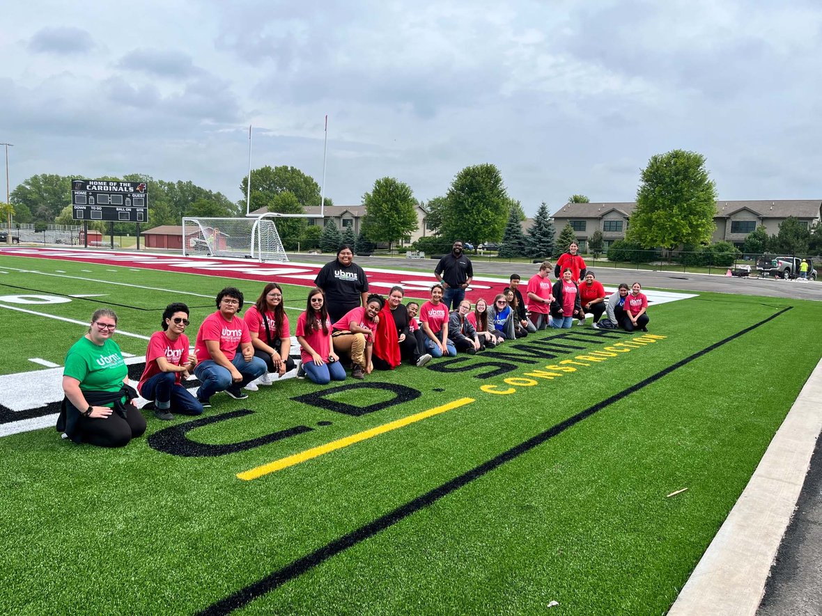 Students in Marian University Summer Academy visit CD Smith Fond du Lac Athletic Stadium endzone for photo opp IMG_1535