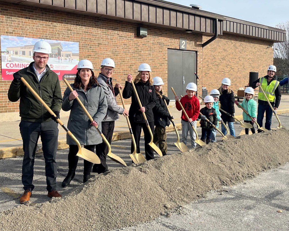 Superintendent students and project team with shovels and CD Smith Construction hard hats at Pulaski School District Sunnyside Project Groundbreaking