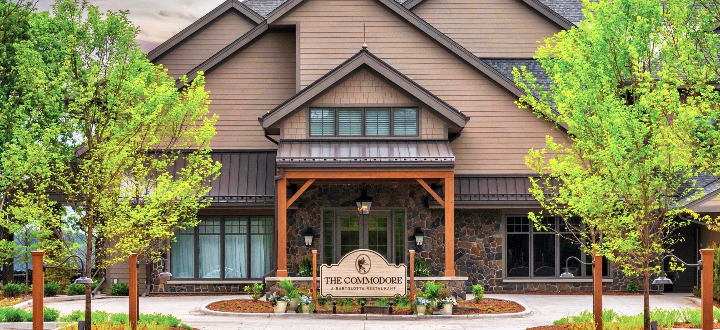 Main entrance of The Commodore featuring stonework and copper cupolas