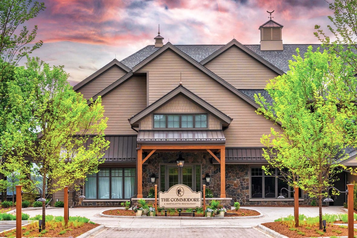 Main entrance of The Commodore featuring stonework and copper cupolas