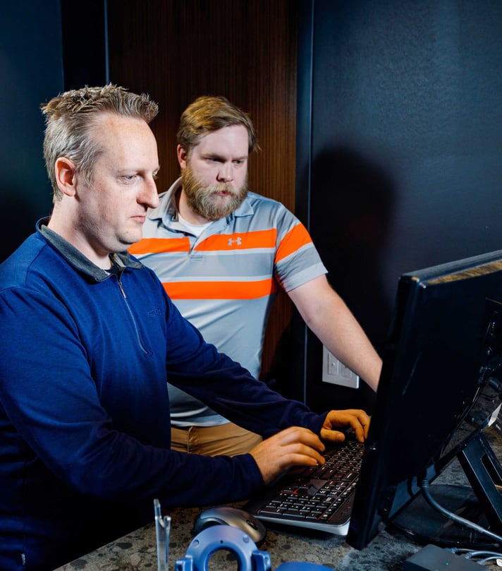 CD Smith Virtual Design + Construction team at desktop monitor navigating virtual project site in collaboration on project in Wisconsin