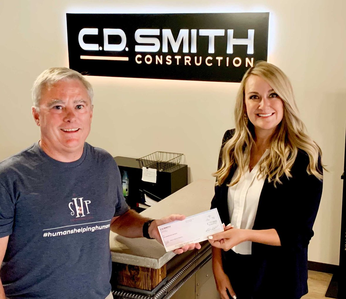 April Krahn (at right) pictured with SHP WI-Waukesha Chapter Co-President Tim Culhane at C.D. Smith Construction's Milwaukee Office