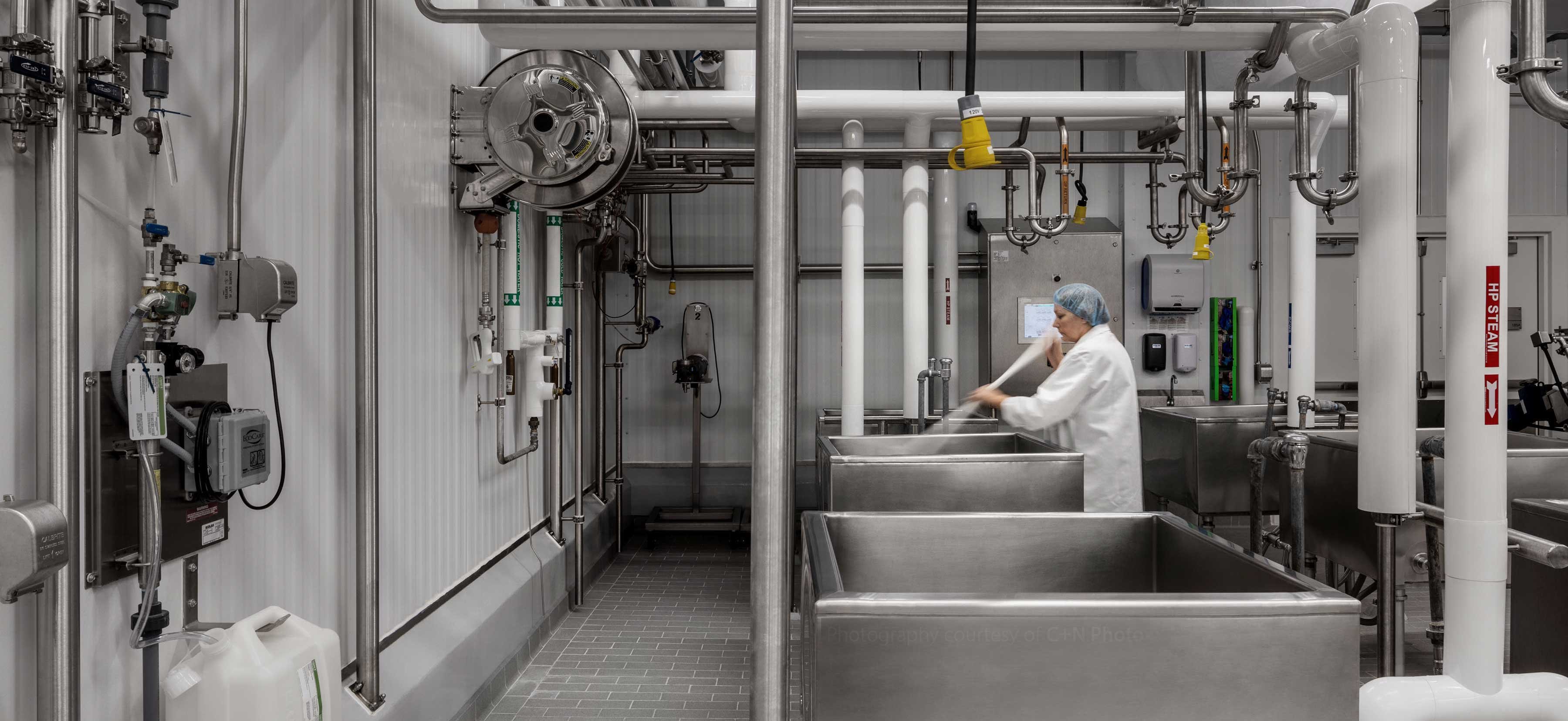 Woman cleaning milk holding tanks at Center for Dairy Research CDR UW-Madison Babcock Hall
