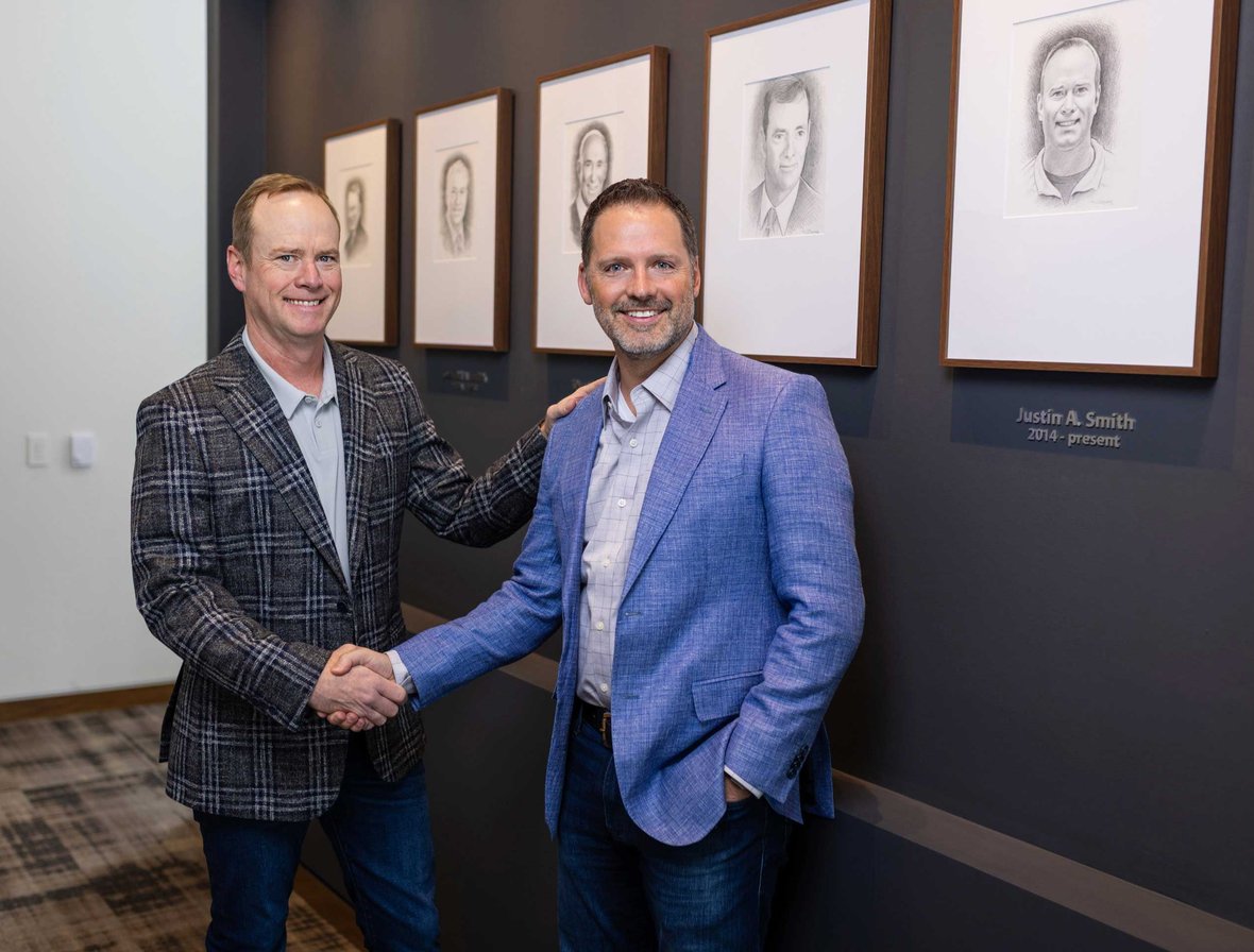 Justin Smith and Norbert ‘Norb’ Schmidt standing together at C.D. Smith Construction, marking Norb’s appointment as President.