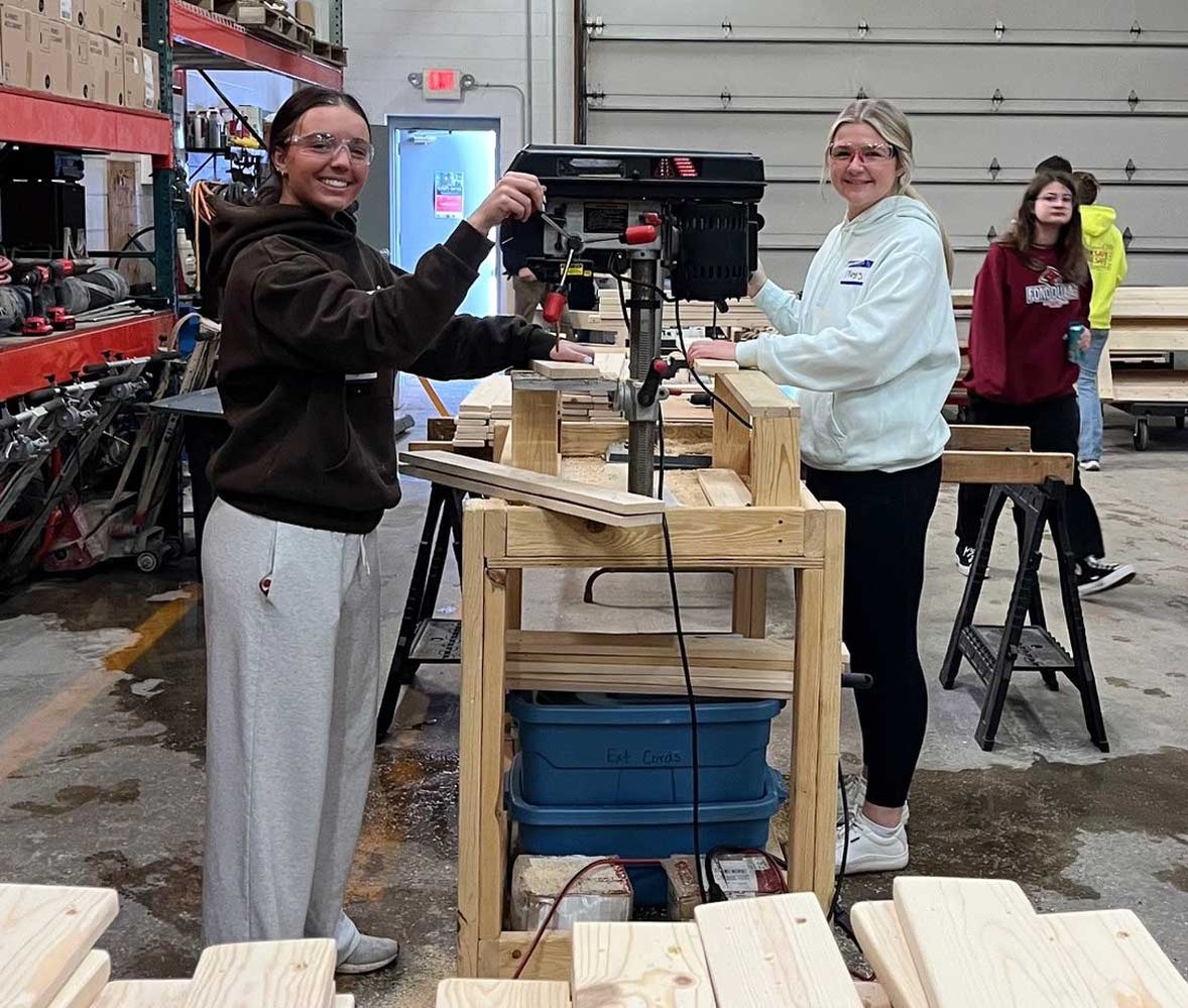 Youth apprentices and local students volunteering and assembling wooden frames at Sleep in Heavenly Peace bed build