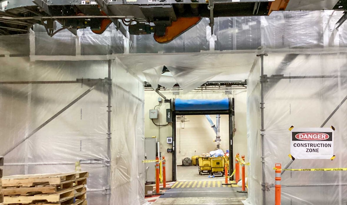 Protected construction access route allowing pallet traffic and sealed box production to continue during facility upgrades at Campbell Snacks.