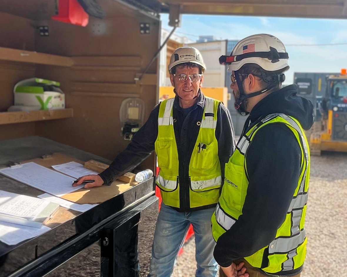 C.D. Smith superintendents and project engineer overseeing the on-site fabrication and tilt-up installation of precast concrete walls.