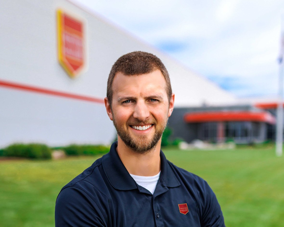 Scott Koenig, Engineering Program Manager at Masters Gallery Foods, standing in front of the facility built by C.D. Smith Construction