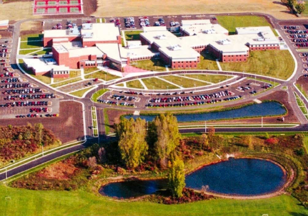 Aerial view of Fond du Lac High School, featuring geothermal heat exchange ponds that support the campus heating and cooling system.
