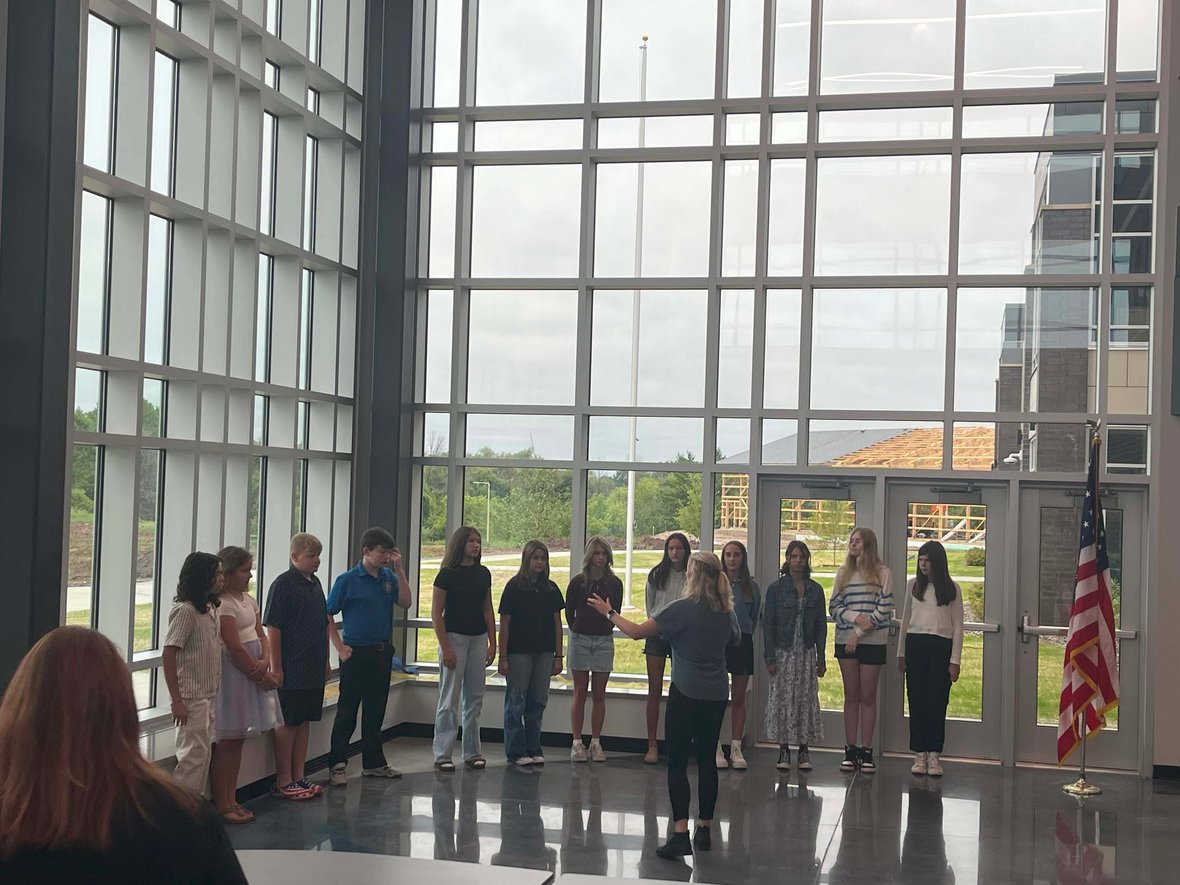 Howards Grove Middle School choir performs the National Anthem at the ribbon cutting celebration inside the new school building.