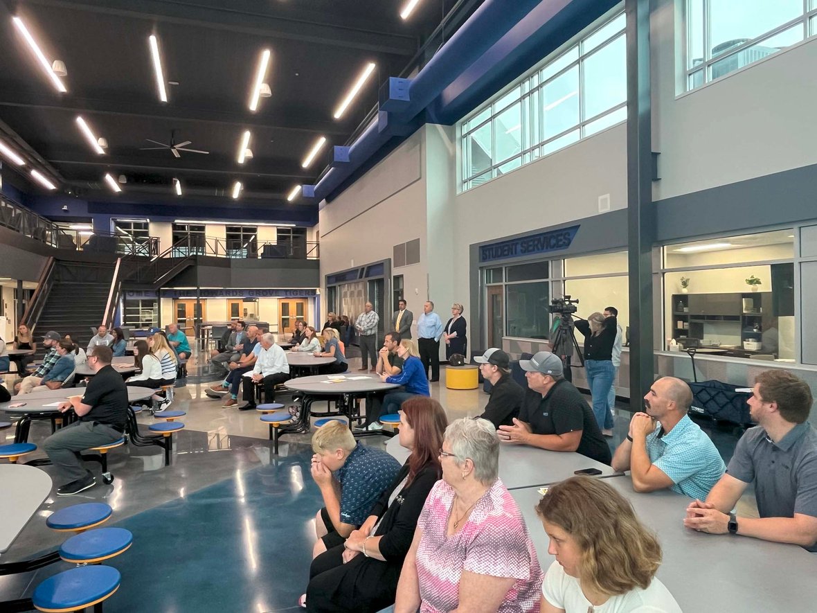 Community members, staff, and project partners gather in the new Howards Grove Middle School common area during the ribbon cutting ceremony.