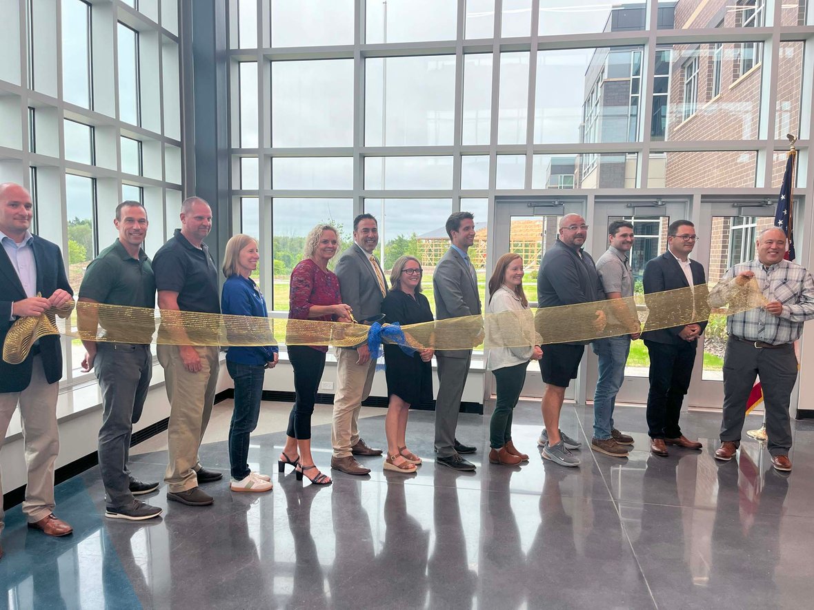 District leaders, community members, and C.D. Smith Construction representatives cut the ribbon to celebrate the opening of the new Howards Grove Middle School.